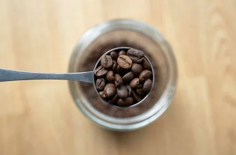 Spoon of coffee with bur background Stock Photos