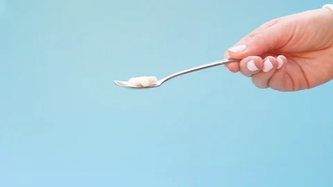 Spoon with collagen in the capsule on blue background. Stock Footage 126707547