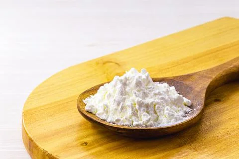 Spoon with cornstarch, flour made from corn used to make creams or as a thick Stock Photos