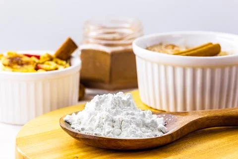 Spoon with cornstarch, flour made from corn used to make creams or as a thick Stock Photos