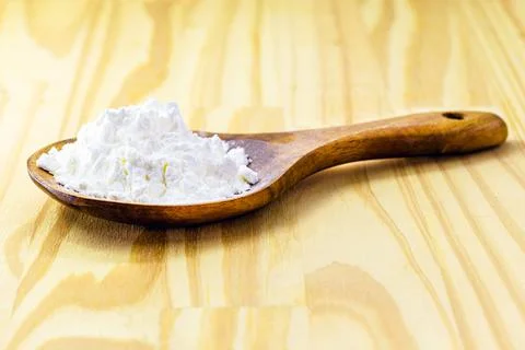 Spoon with cornstarch, flour made from corn used to make creams or as a thick Stock Photos