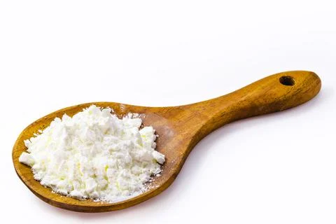 Spoon with cornstarch, flour made from corn used to make creams or as a thick Stock Photos