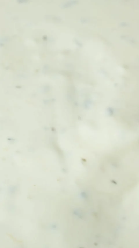 Spoon demonstrating the thick texture of creamy tartar sauce Stock Footage 337701146