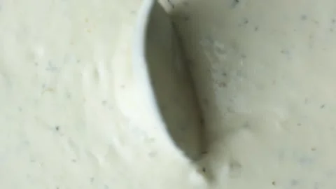 Spoon demonstrating the thick texture of creamy tartar sauce. Stock Footage 337701353