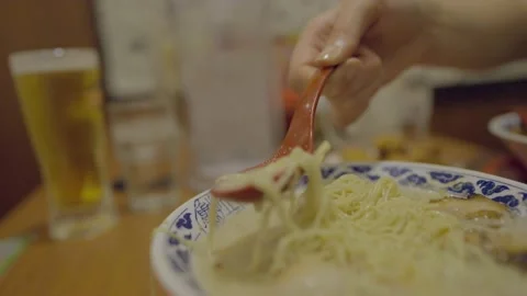 Spoon dips into tonkatsu ramen Stock Footage 233307993