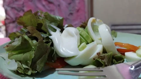 Spoon the dressing onto the salad. Stock Footage 265235586
