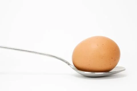 Spoon with an egg Stock Photos