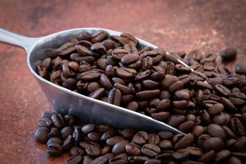 Spoon filled with roasted coffee beans 스톡 사진