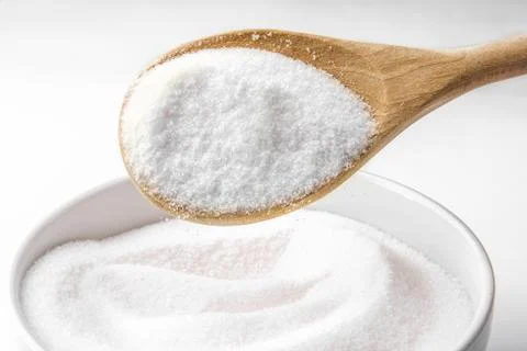 Spoon filled with sugar Stock Photos