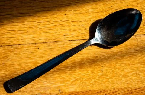 A spoon on the floor shining clean Stock Photos