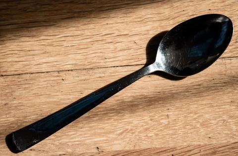 A spoon on the floor shining clean Stock Photos