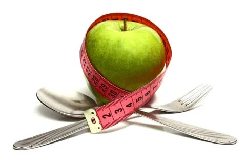 Spoon fork and apple is strung by a ribbon for measuring diet Stock Photos