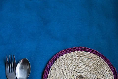Spoon, fork and table mat Stock Photos