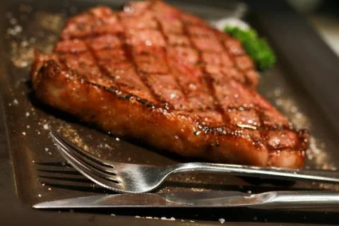 Spoon an fork with blur dry aged rib eye steak menu Stock Photos