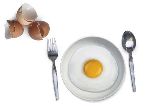 Spoon fork fried egg on plate on a white background Stock Photos