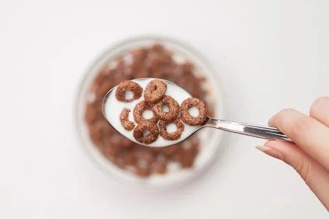 Spoon full of chocolate ringlets in hand close-up breakfast concept Stock Photos