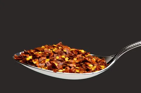 Spoon full of crushed red pepper Stock Photos