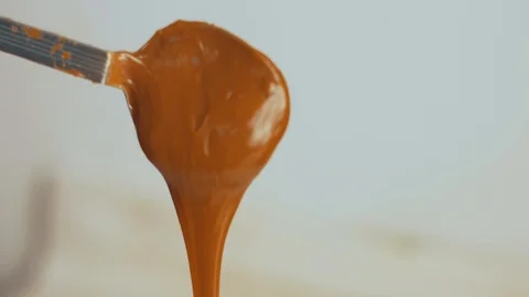 Spoon full of dulce de leche falling down Video stock 90879079
