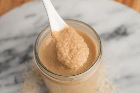 Spoon full over tahini / hummus Stock Photos