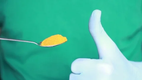 Spoon with grind turmeric and the thumb Stock Footage 80799686