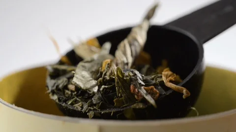 A spoon with herbal tea rises Stock Footage 123904499