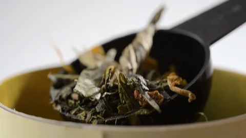 A spoon with herbal tea rises Stock Footage 123904557