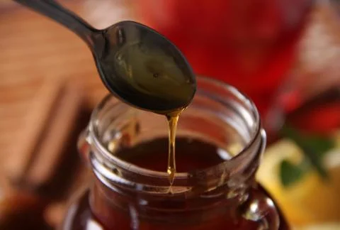 Spoon of honey Stock Photos