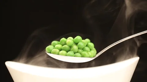 Spoon with hot peas from which emits smoke Stock Footage 43841879