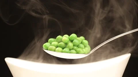Spoon with hot peas from which emits smoke Stock Footage 43841924
