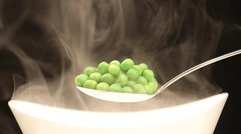 Spoon with hot peas from which emits smoke Stock Footage 43841985