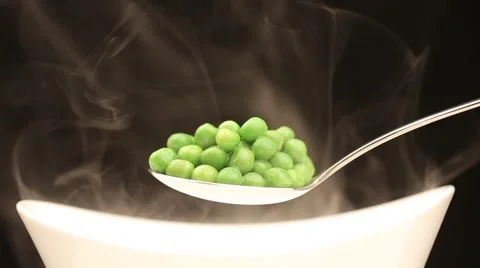 Spoon with hot peas from which emits smoke Stock Footage 43842001