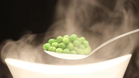 Spoon with hot peas from which emits smoke Stock Footage 43842105