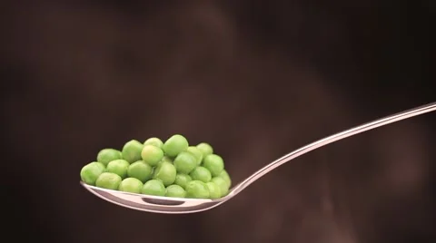 Spoon with hot peas from which emits smoke Stock Footage 43842167