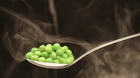 Spoon with hot peas from which emits smoke Stock Footage 43842211
