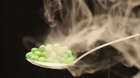 Spoon with hot peas from which emits smoke Stock Footage 43842261