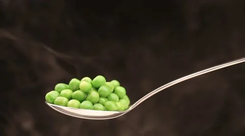 Spoon with hot peas from which emits smoke Stock Footage 43842355