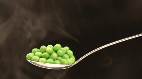 Spoon with hot peas from which emits smoke Stock Footage 43842371