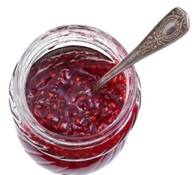 Spoon in jar of raspberry jam Foto stock