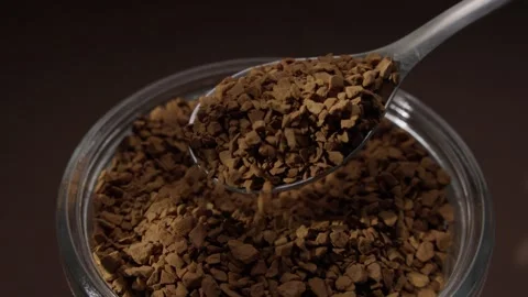 Spoon Lifting Instant Coffee Granules Over a Jar. Stock Footage 287379764