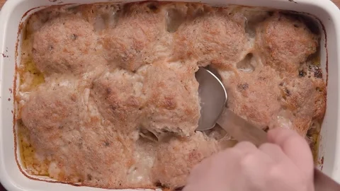 A spoon lifts a cooked meatball from a porcelain bowl Video stock 295277953