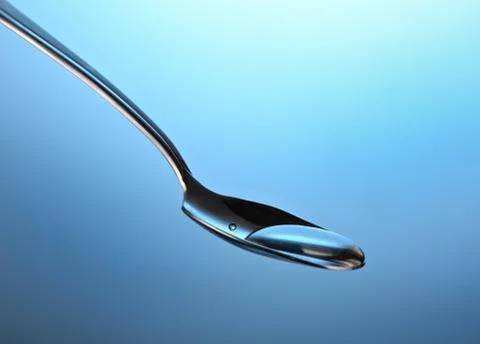Spoon with a liquid Stock Photos
