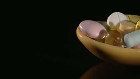 Spoon with medicines close-up on a black background. Stock Footage 146728531