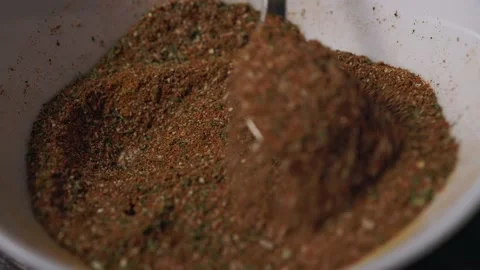With a spoon, mix the spices in one dish close-up slowly. Stock Footage 232138021