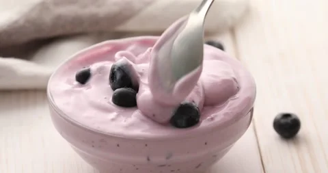 Spoon mixes berries with yogurt. Stock Footage 249358684