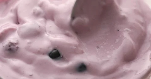 Spoon mixes berries with yogurt. Stock Footage 249358752