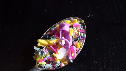 Spoon Moving Plastic Fragments on Dark Table, Highlighting Microplastic Vídeo Stock 297196728
