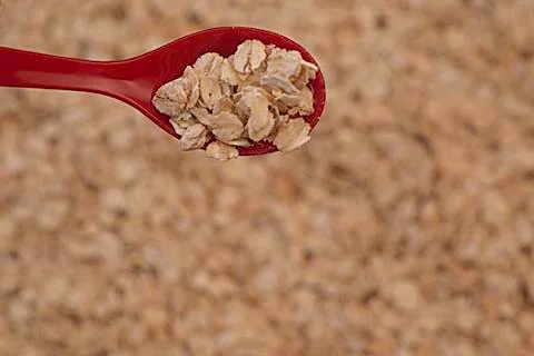 Spoon with oats Stock Photos