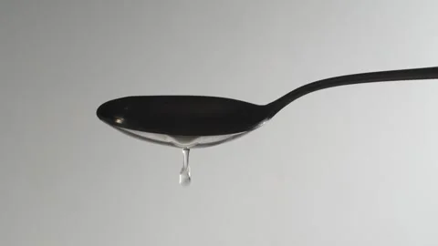 Spoon with Olive Oil on a White Background Video stock 248565715
