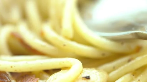 A spoon is in a pan of pasta with cheese Stock Footage 313357146