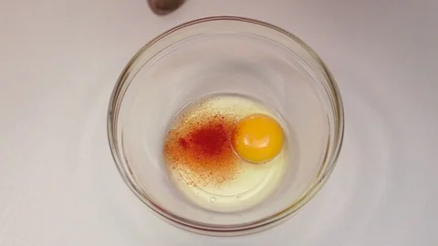 Spoon pepper is added to plate with egg. Slow motion Vidéo 76148000
